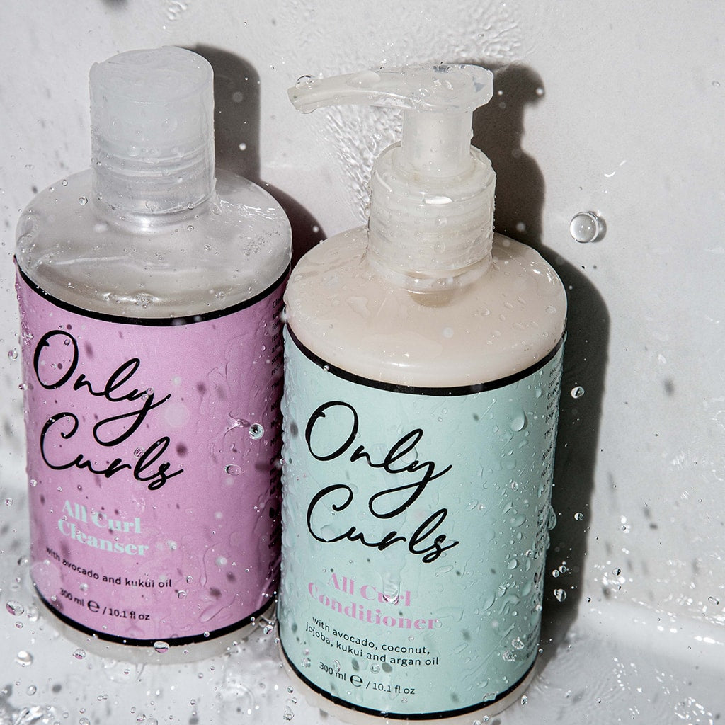 Only Curls Cleanser and Conditioner splashed with water showing extra hydration